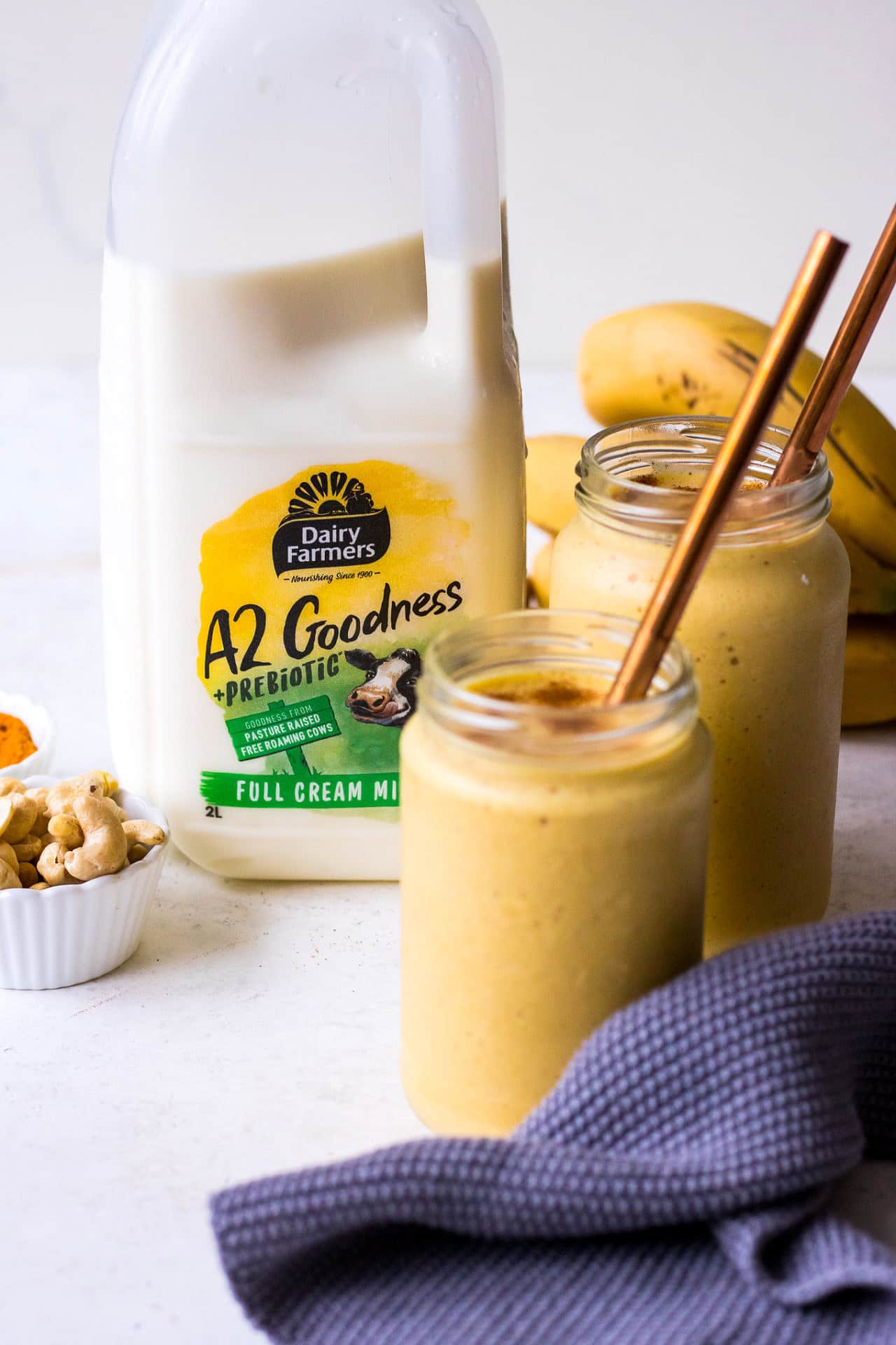 Dairy Farmers A2 Goodness + Prebiotic Milk with smoothie jars and copper straws