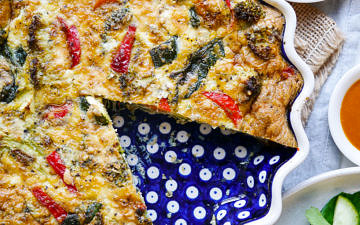 Pesto Vegetable Frittata in a blue ceramic pie dish