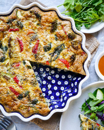 Pesto Vegetable Frittata in a blue ceramic pie dish