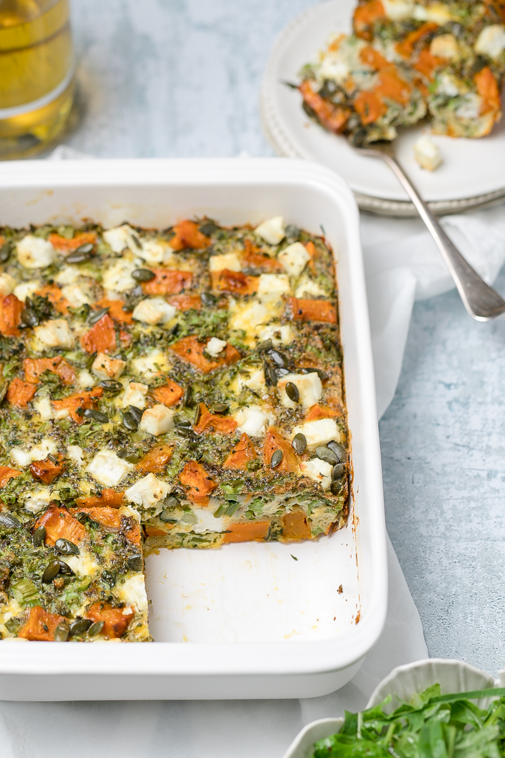 Sweet potato, broccoli and feta frittata in a white rectangular baking dish