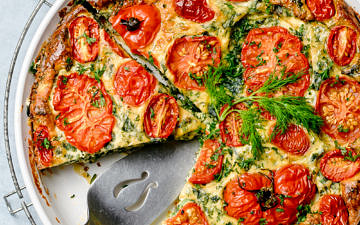 Top down view of a crustless pie made with eggs, ricotta, kale and tomatoes