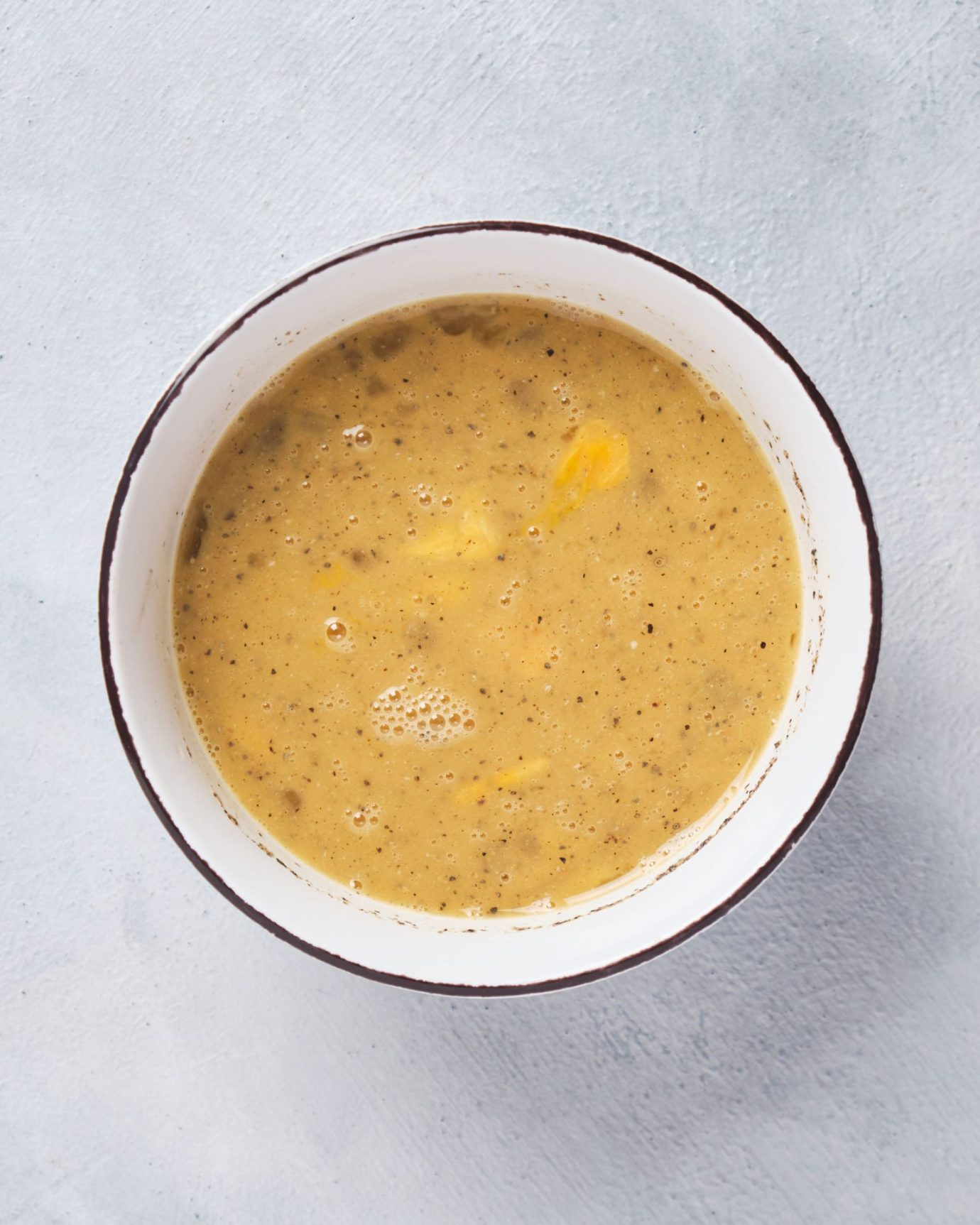 photo of whisked eggs in a white bowl