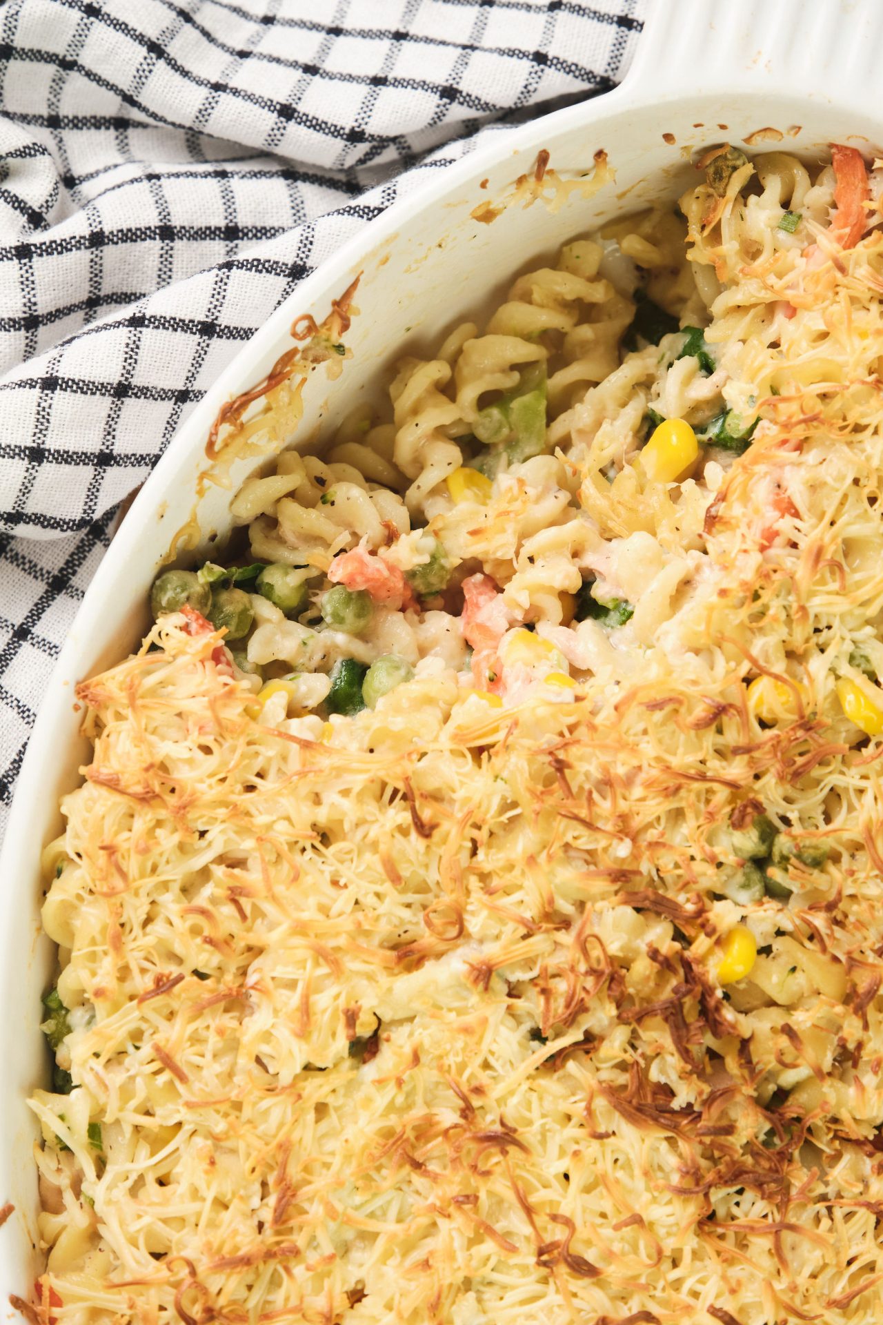 Close up image of a tuna pasta bake with melted cheese on top