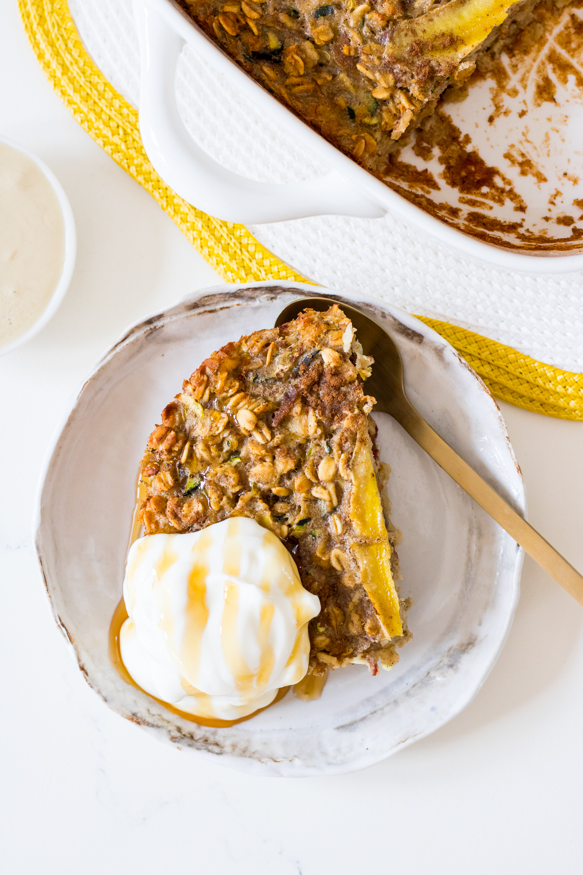 Baked oatmeal with sliced banana in a white square ceramic dish