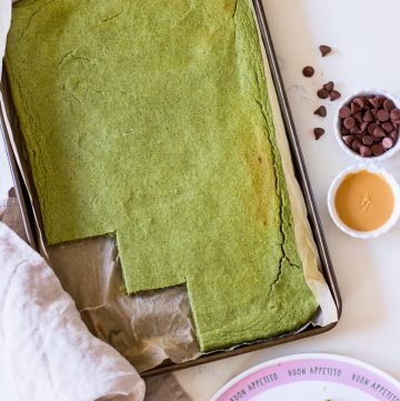 Image of healthy green pancakes baked in a baking tray, the edge cut into squares