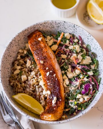Image of brown sugar glazed salmon fillet in a bowl with slaw and brown rice