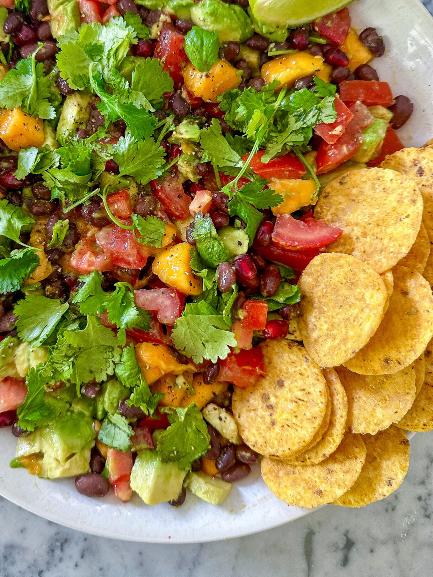 Healthy cowgirl caviar dip with black beans and avocado, served with tortilla chips.