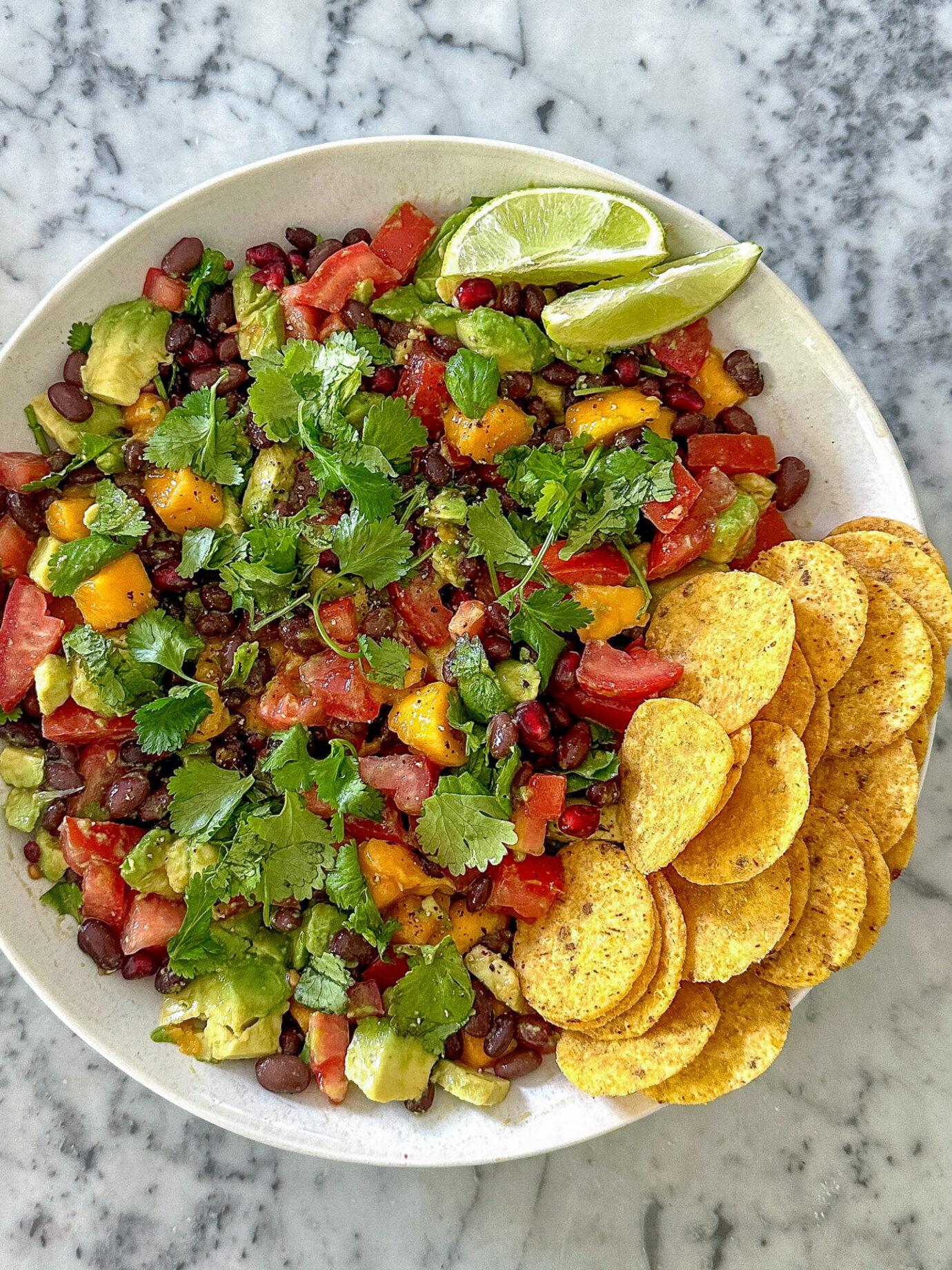 Healthy cowgirl caviar dip with black beans and avocado, served with tortilla chips.