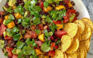 Healthy cowgirl caviar dip with black beans and avocado, served with tortilla chips.