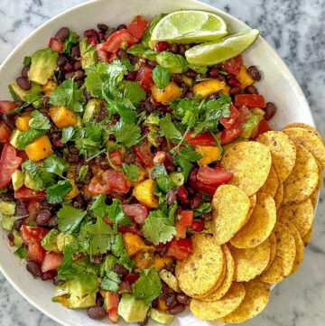 Healthy cowgirl caviar dip with black beans and avocado, served with tortilla chips.