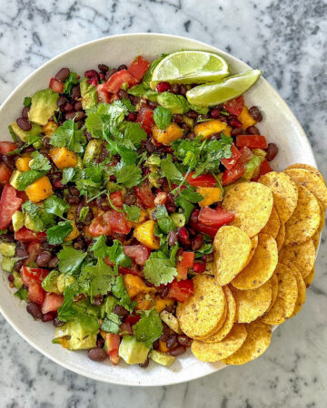 Healthy cowgirl caviar dip with black beans and avocado, served with tortilla chips.
