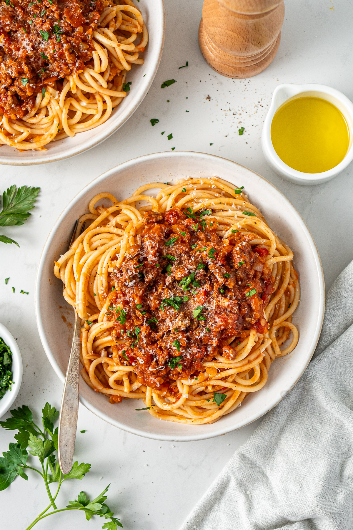 Everyday healthy bolognese sauce made with lean beef and red lentils, freezer friendly, served with spaghetti pasta and parmesan.